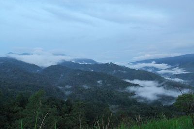 Scenic view of mountains against cloudy sky