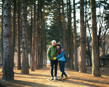 Full length of couple walking in forest