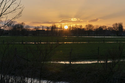 Scenic view of field against sky during sunset