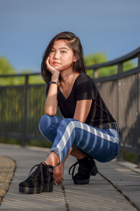 Portrait of young woman sitting on staircase