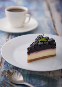 Close-up of cake with coffee on table