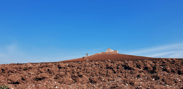 Scenic view of land against clear blue sky