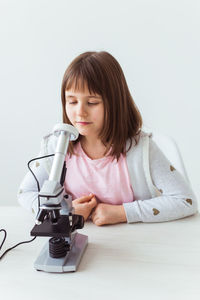 Portrait of girl sitting on table