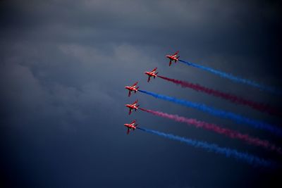 Low angle view of airshow against sky