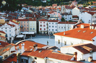 Red roofs of old town piran with main church against the sunrise sky, adriatic sea. slovenia