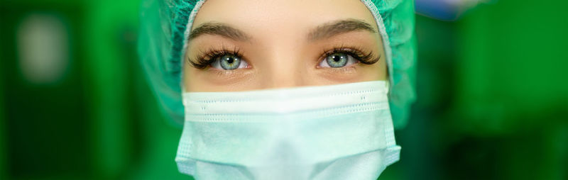 Close-up of young woman wearing mask