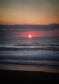 Scenic view of sea against romantic sky at sunset