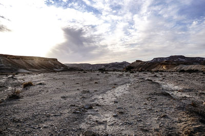 Scenic view of arid landscape against sky