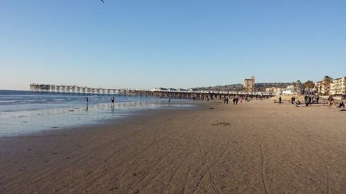 Scenic view of beach against blue sky