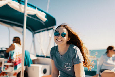 Young woman wearing sunglasses against sky