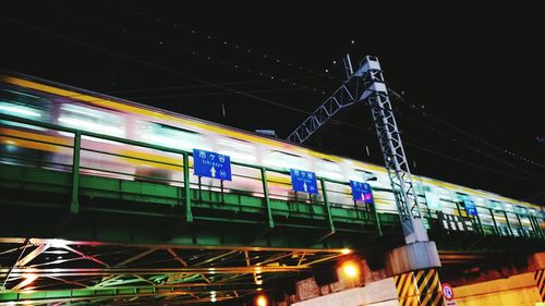 Low angle view of train at railroad station at night