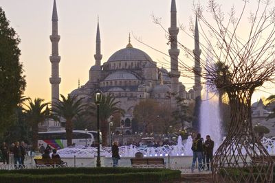 People at blue mosque against sky