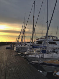 Boats in harbor at sunset