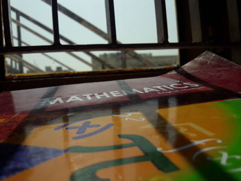 Close-up of text on glass window at home