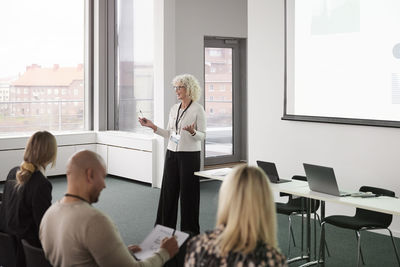 Woman having presentation during business seminar