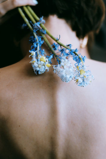 Midsection of woman with bouquet