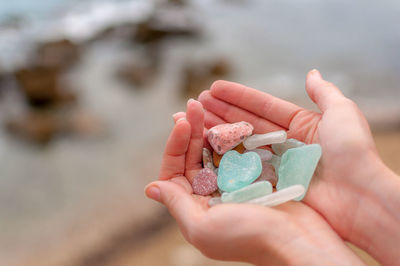 Cropped hands of person holding gemstones