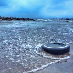 Scenic view of sea against cloudy sky