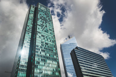 Low angle view of modern glass building against sky