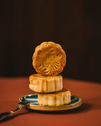 Close-up of cake on table against black background