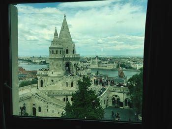 High angle view of church against cloudy sky