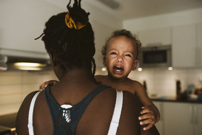 Mother carry crying toddler