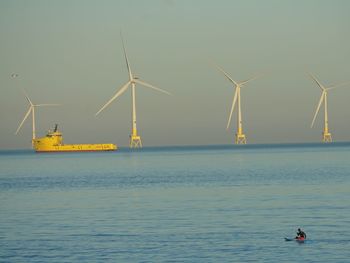View of supply boots amongst wind turbines in the bay of aberdeen scotland 