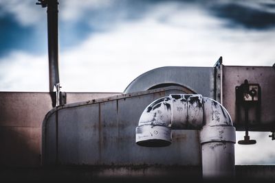 Close-up of metal structure against sky