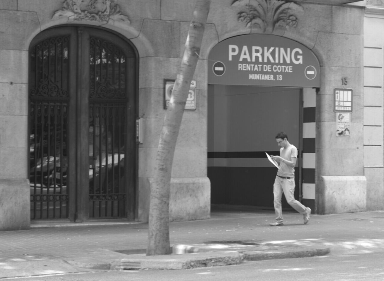 WOMAN STANDING IN FRONT OF BUILDING