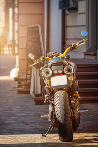 Close-up of motor scooter on street