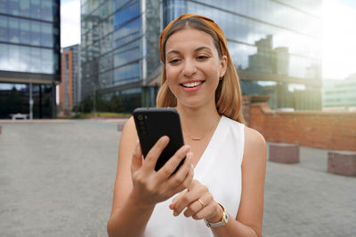 Beautiful business woman using mobile phone outdoors. people communication technology concept.