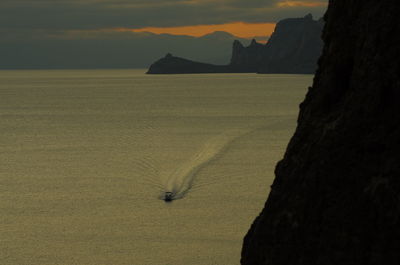 Scenic view of sea and mountains against sky