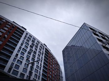 Low angle view of modern buildings against sky in city