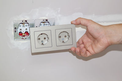 Close-up of man photographing against white background