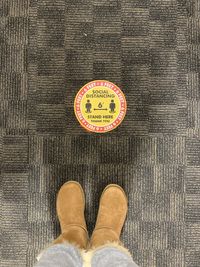 Low section of man standing on carpet