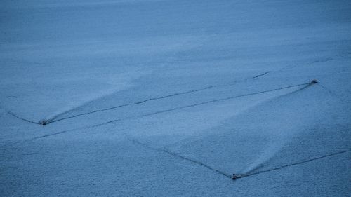 High angle view of snow covered field against sky