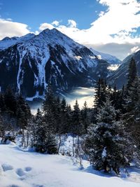 Scenic view of snow covered mountains against sky