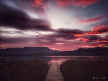 Scenic view of lake against sky during sunset