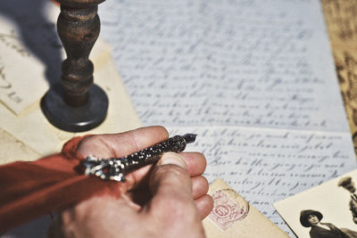 Close-up of hand holding book