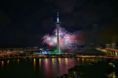 Low angle view of illuminated fireworks against sky at night