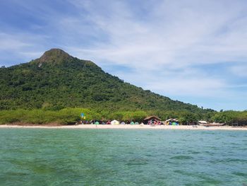 Scenic view of sea and mountains against sky