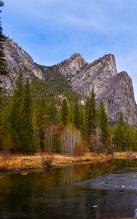 Scenic view of lake and  rugged  mountains of yosemite three brothers against  bluesky