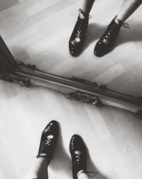 Low section of woman standing on tiled floor