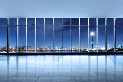 Cityscape seen through modern building at night