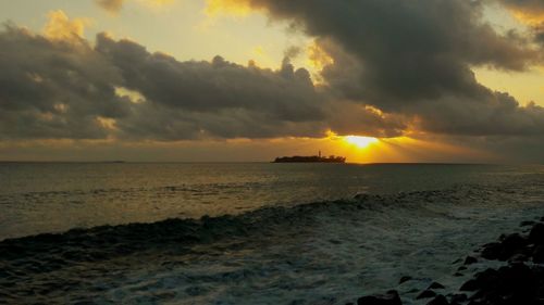 Scenic view of sea against dramatic sky