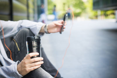 Midsection of man using mobile phone