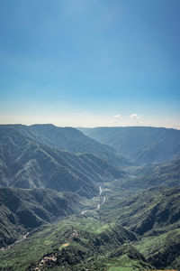 Misty mountain range covered with white mist and amazing blue sky