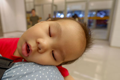 Close-up of cute baby boy sleeping indoors