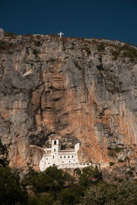 Low angle view of rock formations on mountain prekornica and the ostrog monastery