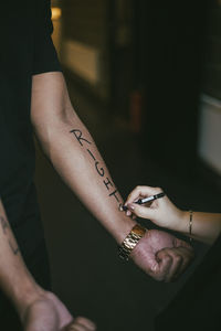 Midsection of couple holding hands